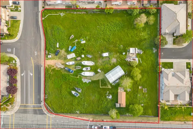 an aerial view of a residential houses with yard