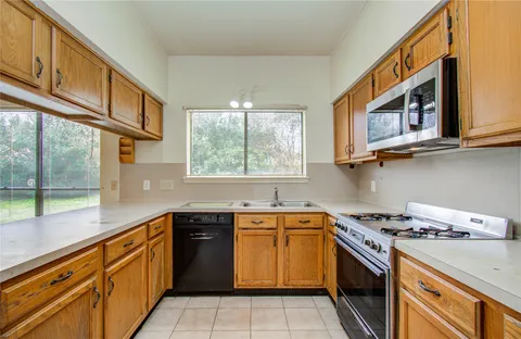 a kitchen with stainless steel appliances granite countertop a refrigerator and cabinets