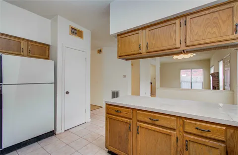 a kitchen with stainless steel appliances granite countertop a stove a microwave and a refrigerator