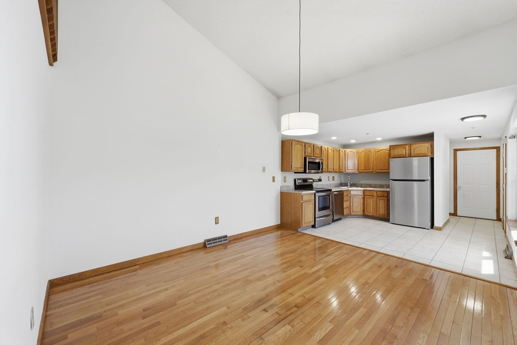 18 Castle Hills Road, Unit G Agawam, MA 01001 - Photo 11 of 39 a open kitchen with cabinets and wooden floor