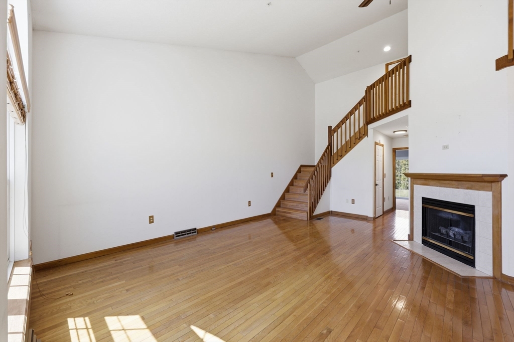 18 Castle Hills Road, Unit G Agawam, MA 01001 - Photo 12 of 39 a view of an empty room with wooden floor and staircase
