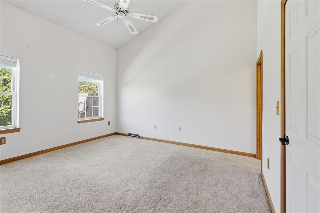 18 Castle Hills Road, Unit G Agawam, MA 01001 - Photo 16 of 39 an empty room with fan and windows