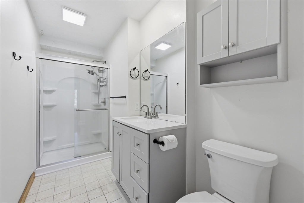 18 Castle Hills Road, Unit G Agawam, MA 01001 - Photo 19 of 39 a bathroom with a sink a toilet and shower