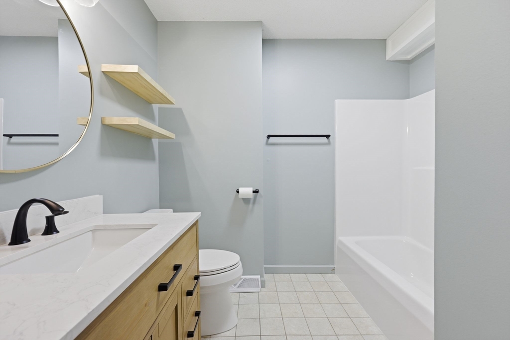 18 Castle Hills Road, Unit G Agawam, MA 01001 - Photo 22 of 39 a bathroom with a sink a toilet and shower