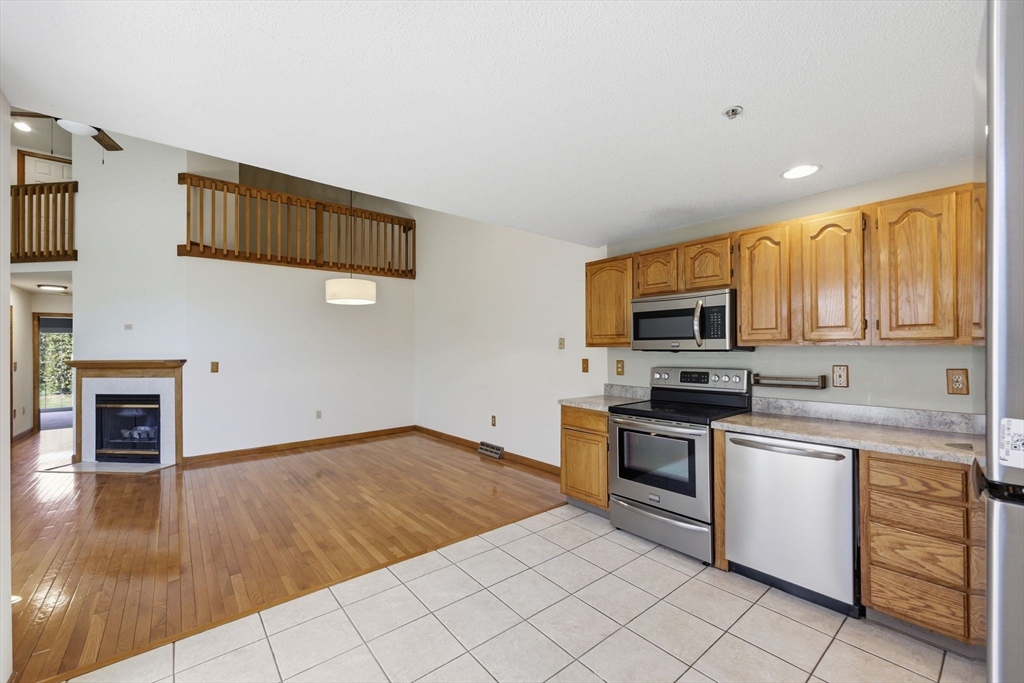 18 Castle Hills Road, Unit G Agawam, MA 01001 - Photo 4 of 39 a kitchen with stainless steel appliances granite countertop a stove a sink and a microwave