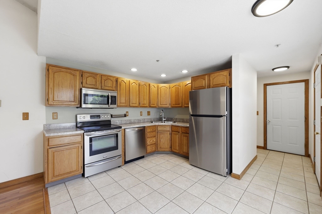 18 Castle Hills Road, Unit G Agawam, MA 01001 - Photo 5 of 39 a kitchen with stainless steel appliances granite countertop a refrigerator sink and stove