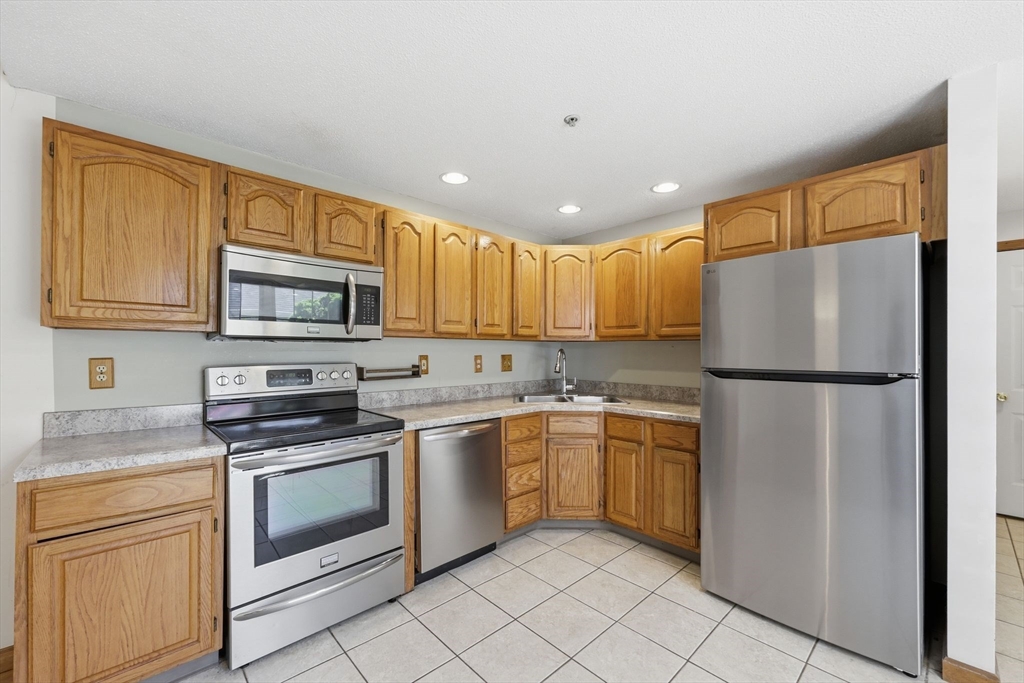 18 Castle Hills Road, Unit G Agawam, MA 01001 - Photo 6 of 39 a kitchen with a refrigerator sink and microwave
