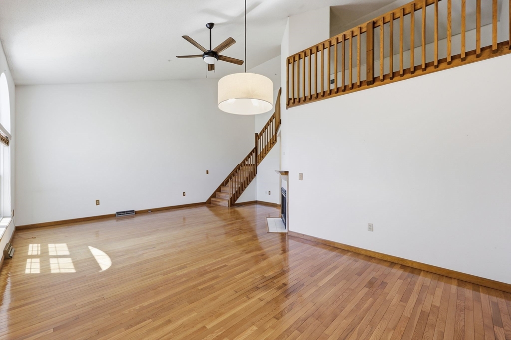 18 Castle Hills Road, Unit G Agawam, MA 01001 - Photo 9 of 39 a view of a livingroom with wooden floor and a ceiling fan