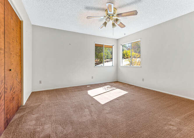 41000 Oak Ridge Drive Three Rivers, CA 93271 - Photo 20 of 39 an empty room with windows and ceiling fan