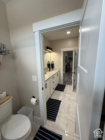 1240 West 2360 North Helper, UT 84526 - Photo 60 of 79 Bathroom with baseboards, marble finish floor, toilet, and vanity