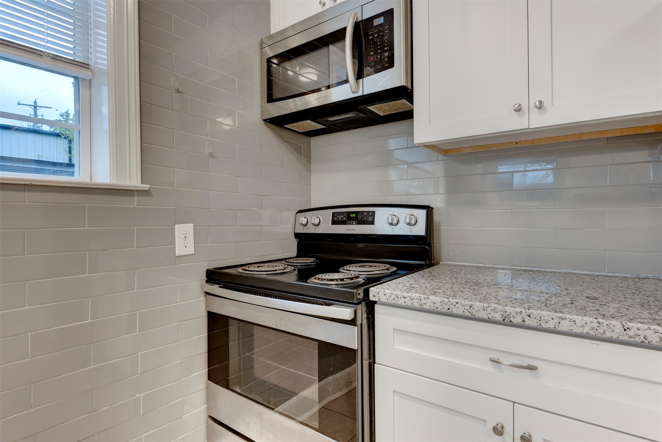 2127 Maximilian Street, Unit 10 Houston, TX 77039 - Photo 11 of 11 a kitchen with granite countertop cabinets stainless steel appliances and wooden floor