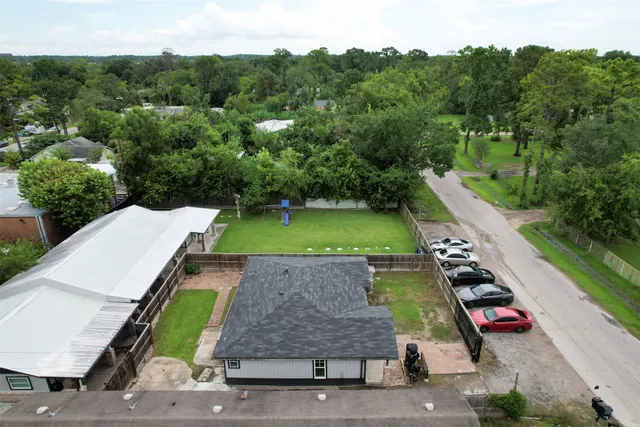 an aerial view of a backyard with swimming pool