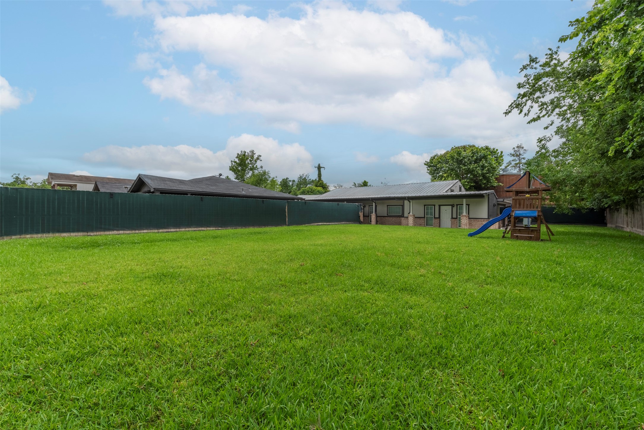 2127 Maximilian Street, Unit 10 Houston, TX 77039 - Photo 4 of 11 a view of a green field with wooden fence