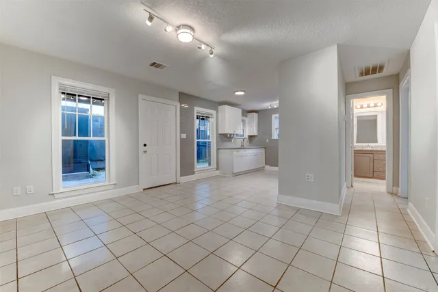 a view of a electric appliances and windows in a room