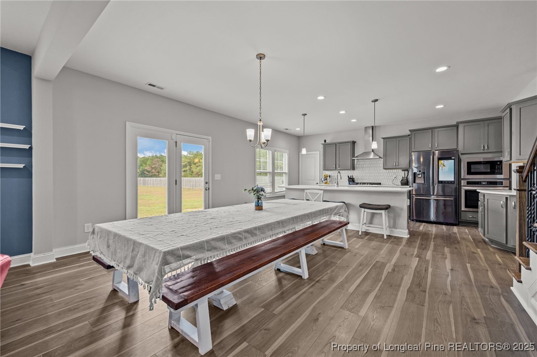 3079 Wade-Stedman Road Stedman, NC 28391 - Photo 16 of 50 a room with stainless steel appliances kitchen island granite countertop a table chairs sink and cabinets