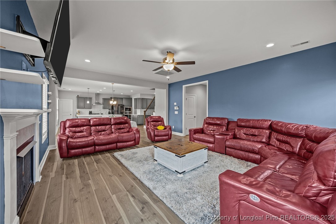 3079 Wade-Stedman Road Stedman, NC 28391 - Photo 20 of 50 a living room with furniture a fireplace and a chandelier