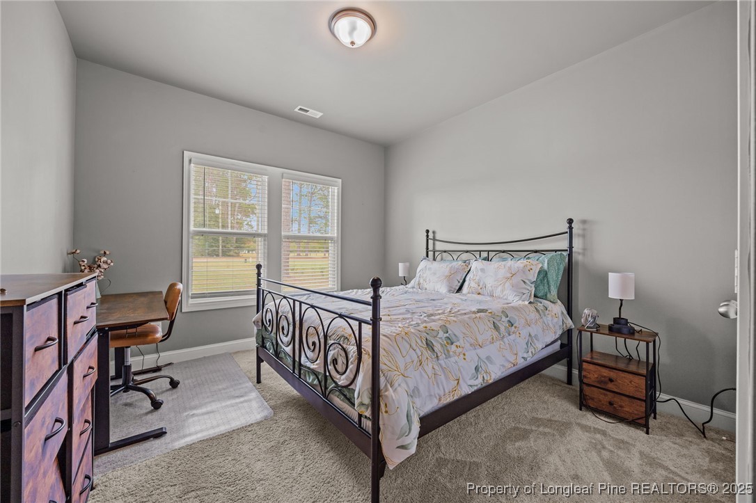 3079 Wade-Stedman Road Stedman, NC 28391 - Photo 21 of 50 a bed room with a bed and a chair
