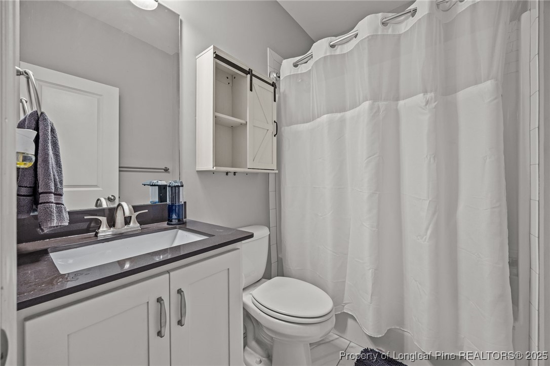 3079 Wade-Stedman Road Stedman, NC 28391 - Photo 22 of 50 a bathroom with a sink toilet and shower