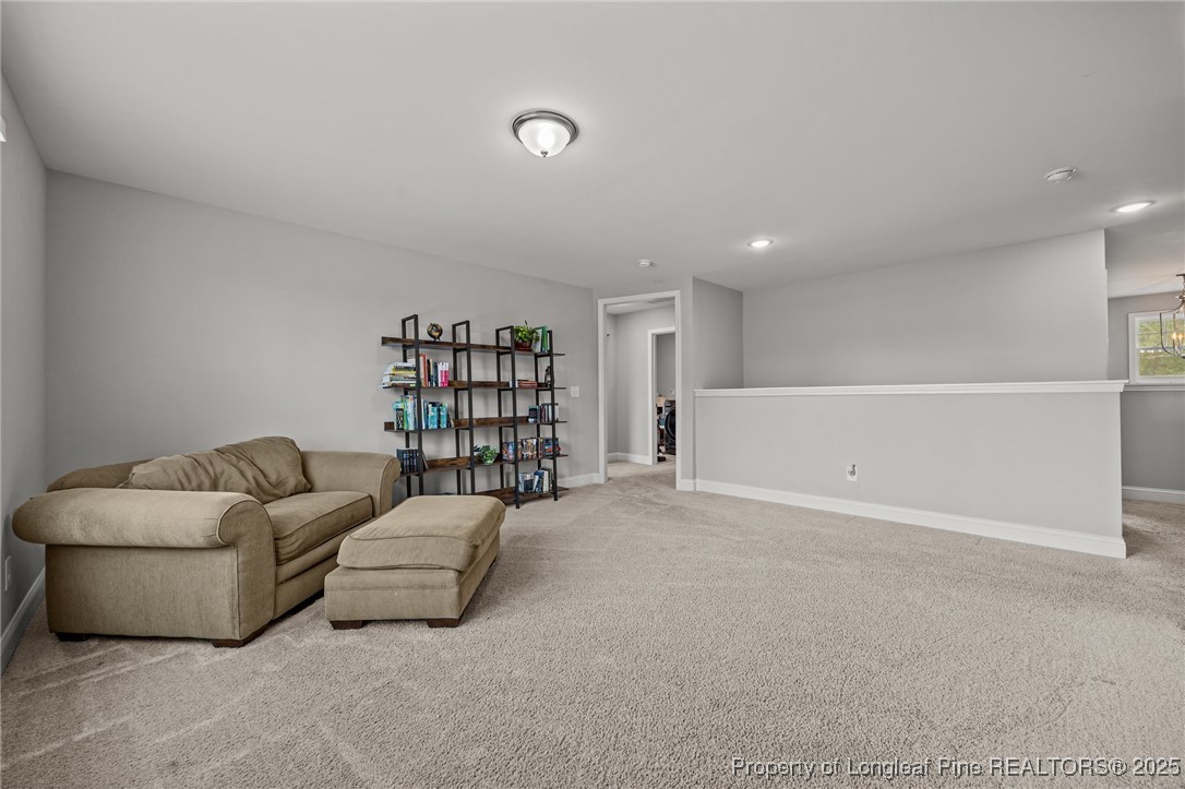 3079 Wade-Stedman Road Stedman, NC 28391 - Photo 25 of 50 a living room with furniture and a book shelf