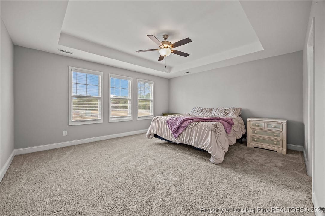 3079 Wade-Stedman Road Stedman, NC 28391 - Photo 27 of 50 a spacious bedroom with a bed and a large window