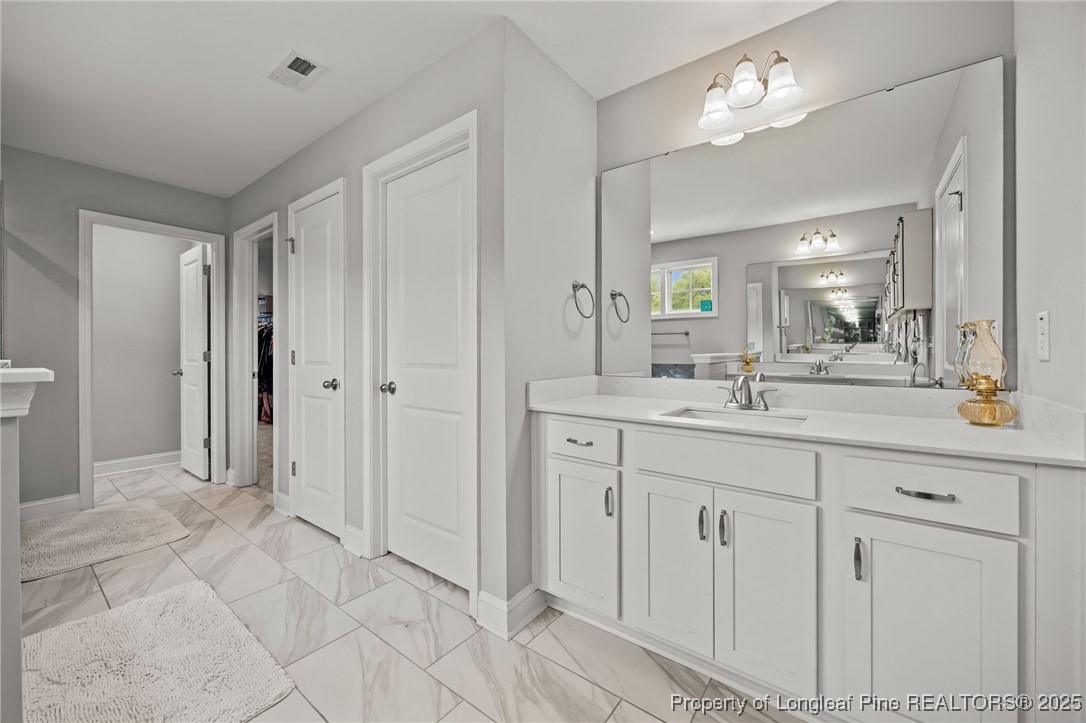 3079 Wade-Stedman Road Stedman, NC 28391 - Photo 30 of 50 a bathroom with a double vanity sink and a mirror