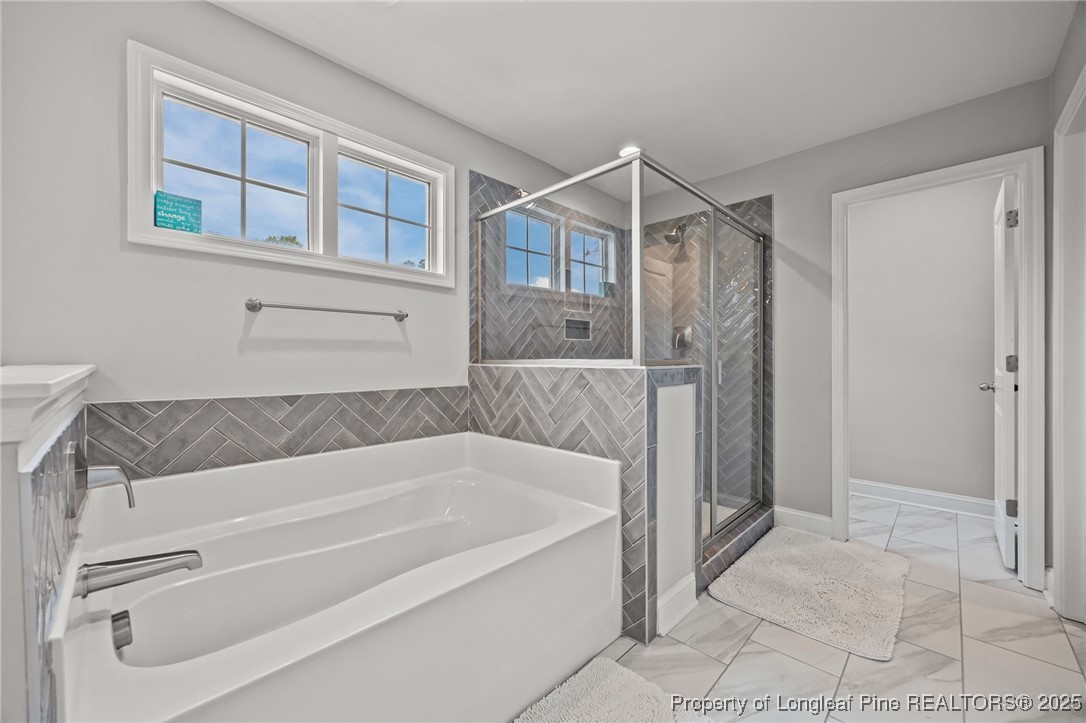 3079 Wade-Stedman Road Stedman, NC 28391 - Photo 31 of 50 a bathroom with a bathtub and a shower