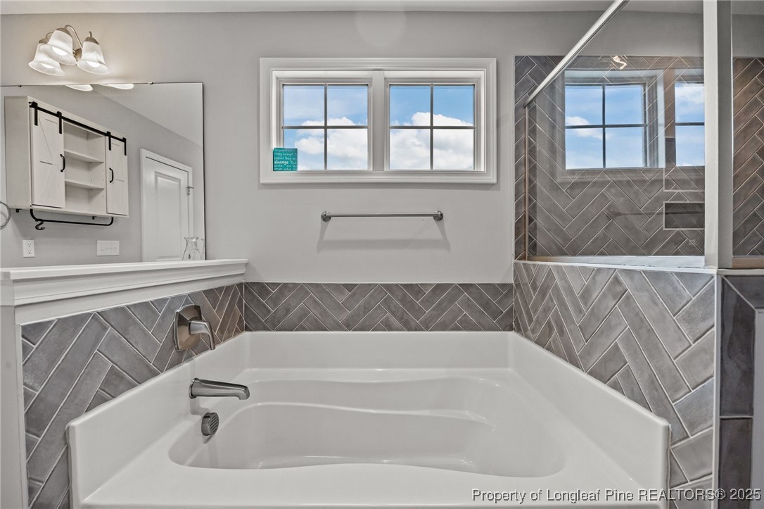 3079 Wade-Stedman Road Stedman, NC 28391 - Photo 32 of 50 a bathroom with a bathtub and a shower