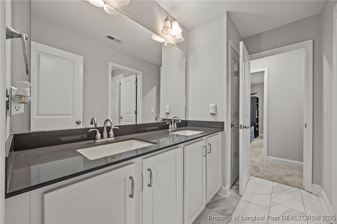 3079 Wade-Stedman Road Stedman, NC 28391 - Photo 41 of 50 a bathroom with double sink and a mirror