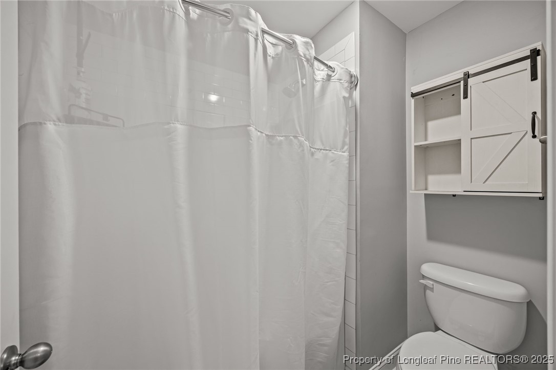 3079 Wade-Stedman Road Stedman, NC 28391 - Photo 42 of 50 a white toilet sitting next to a shower