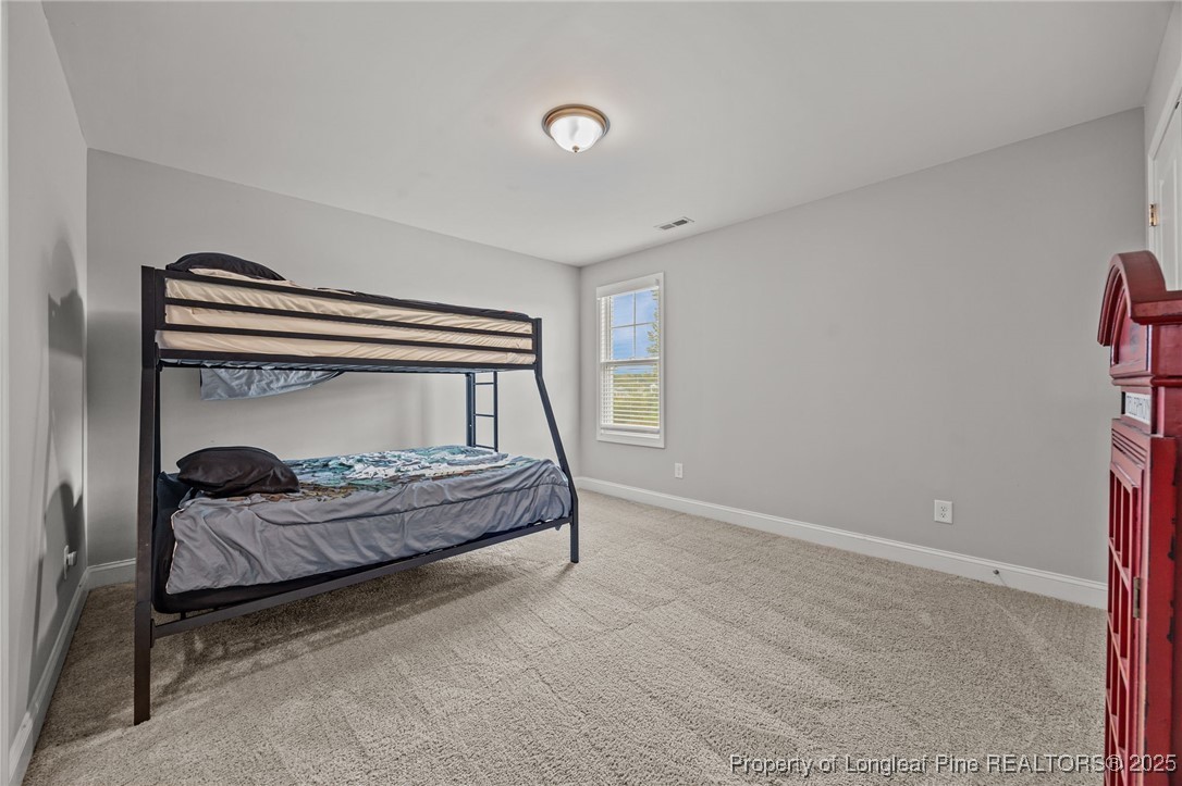 3079 Wade-Stedman Road Stedman, NC 28391 - Photo 43 of 50 a bedroom with a bed and a window