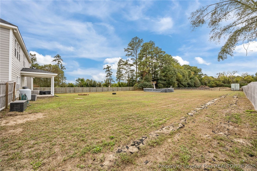 3079 Wade-Stedman Road Stedman, NC 28391 - Photo 46 of 50 a view of an house with backyard and a tree