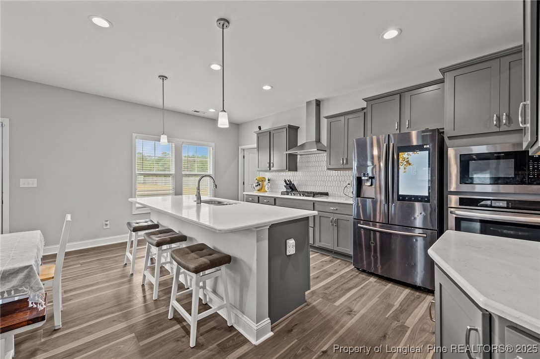 3079 Wade-Stedman Road Stedman, NC 28391 - Photo 8 of 50 a kitchen with stainless steel appliances granite countertop a refrigerator a sink dishwasher a stove and white cabinets with wooden floor