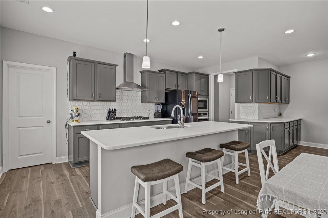 3079 Wade-Stedman Road Stedman, NC 28391 - Photo 9 of 50 a kitchen with a table chairs microwave and cabinets