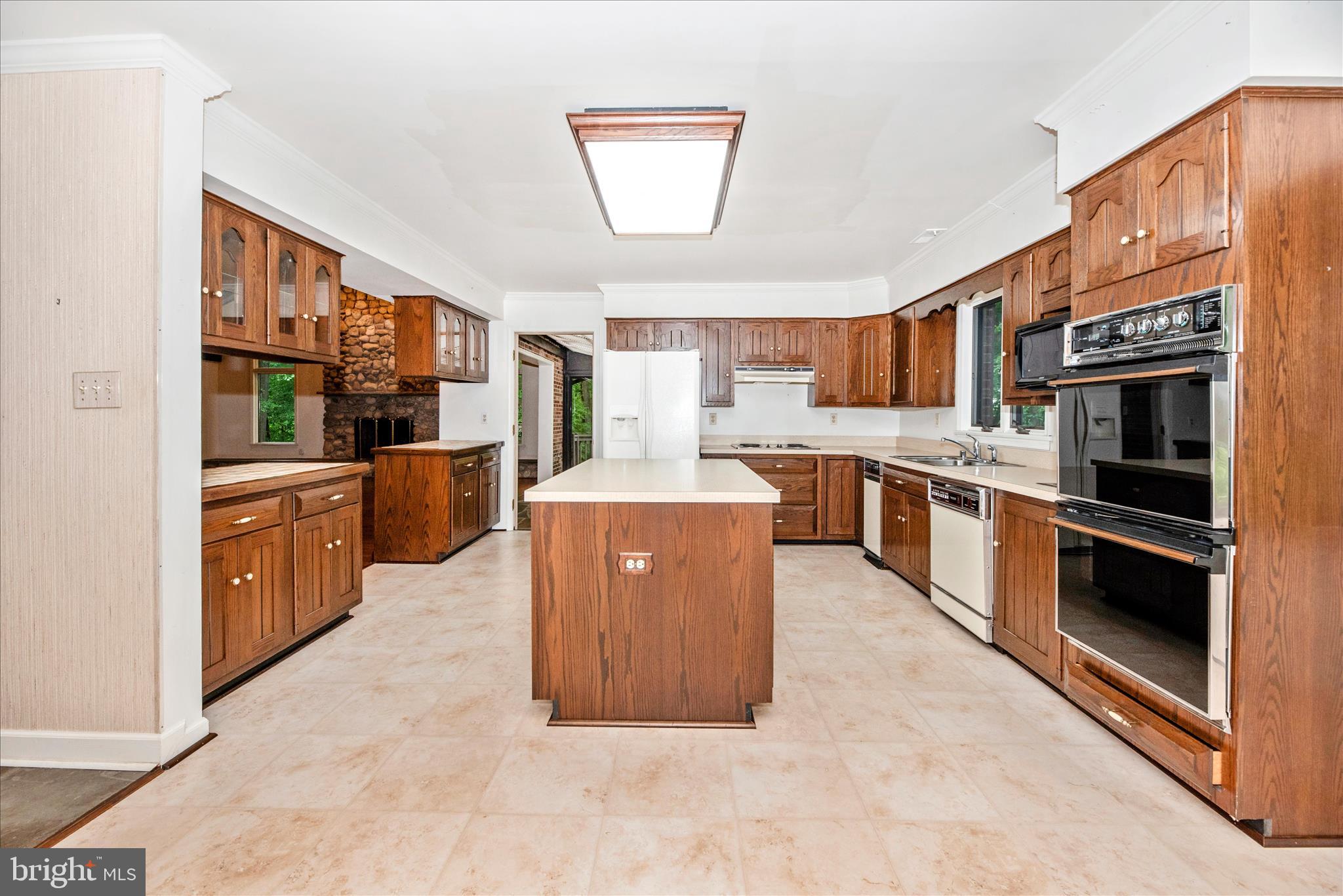 2221 Gold Mine Road Brookeville, MD 20833 - Photo 22 of 60 a large kitchen with stainless steel appliances granite countertop a stove and a sink