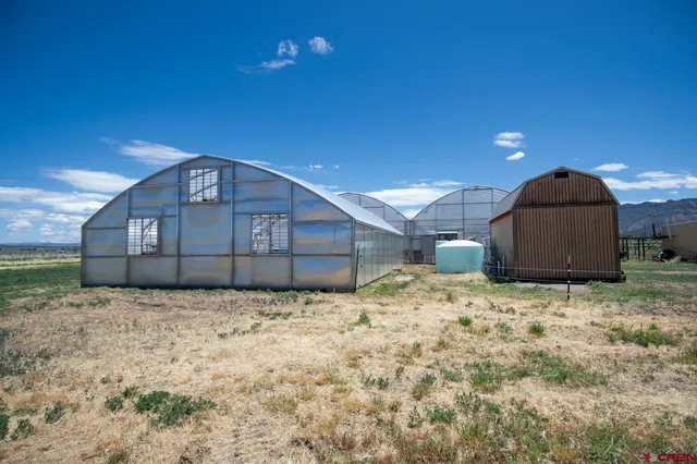 a view of a wooden house with a yard