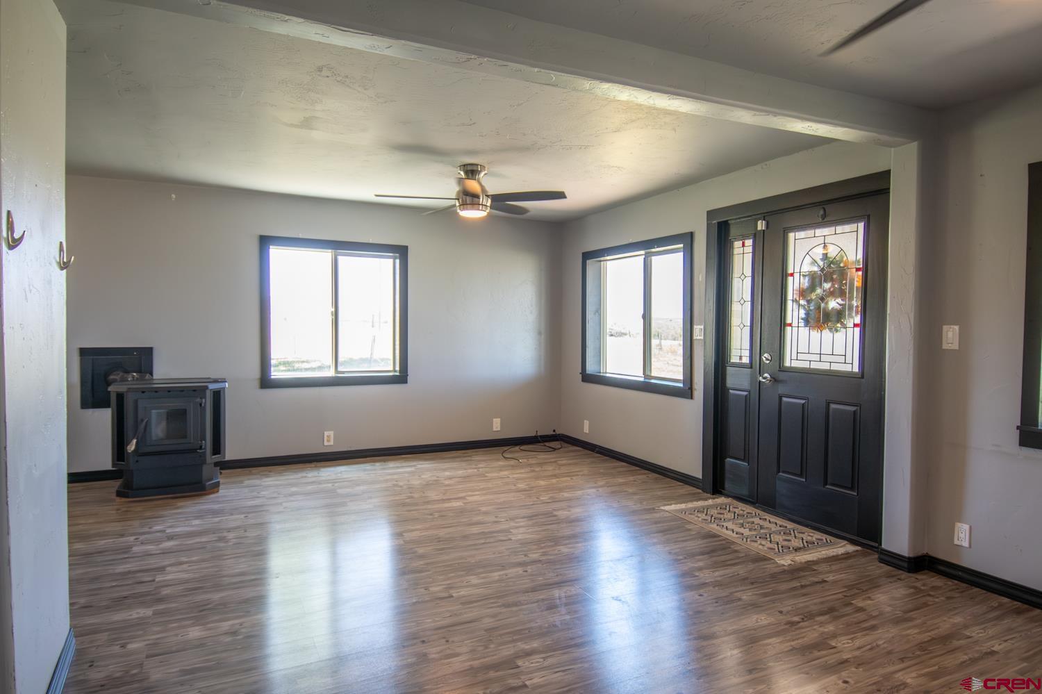 5200 Road 21 Cortez, CO 81321 - Photo 2 of 38 a view of an empty room with a window and wooden floor