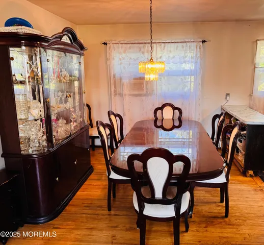 a living room with furniture a flat screen tv and a large window