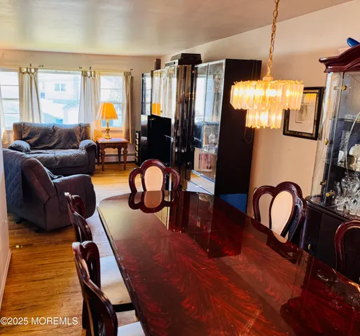 a view of a dining room with furniture and chandelier