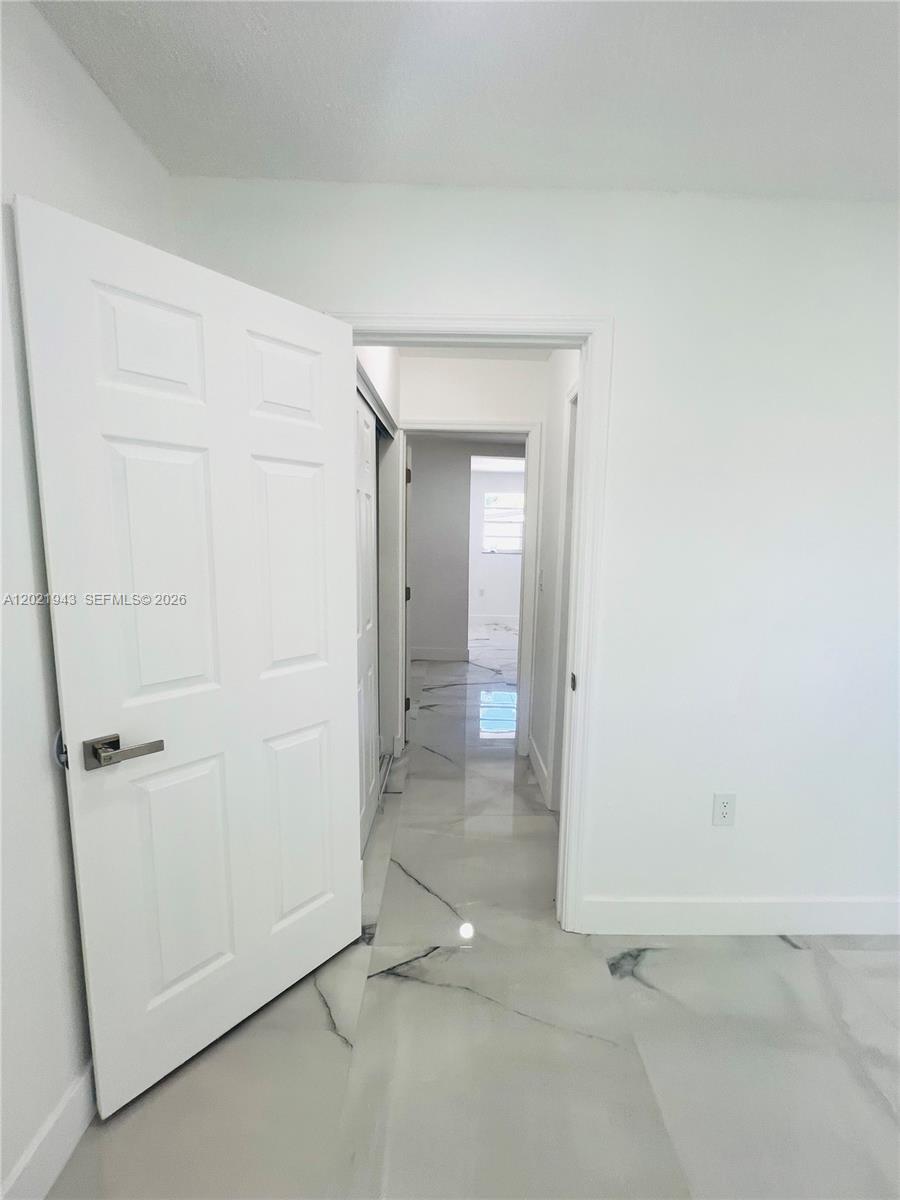 15530 Southwest 295th Terrace Homestead, FL 33033 - Photo 12 of 14 an empty room with a bench