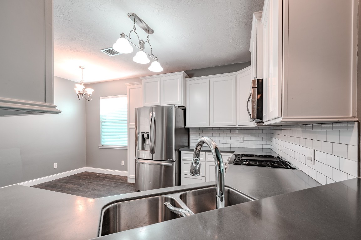 8515 Holly Spring Lane Baytown, TX 77523 - Photo 12 of 28 Beautiful kitchen, newly remodeled with cabinets, backsplash, countertops and appliances.
