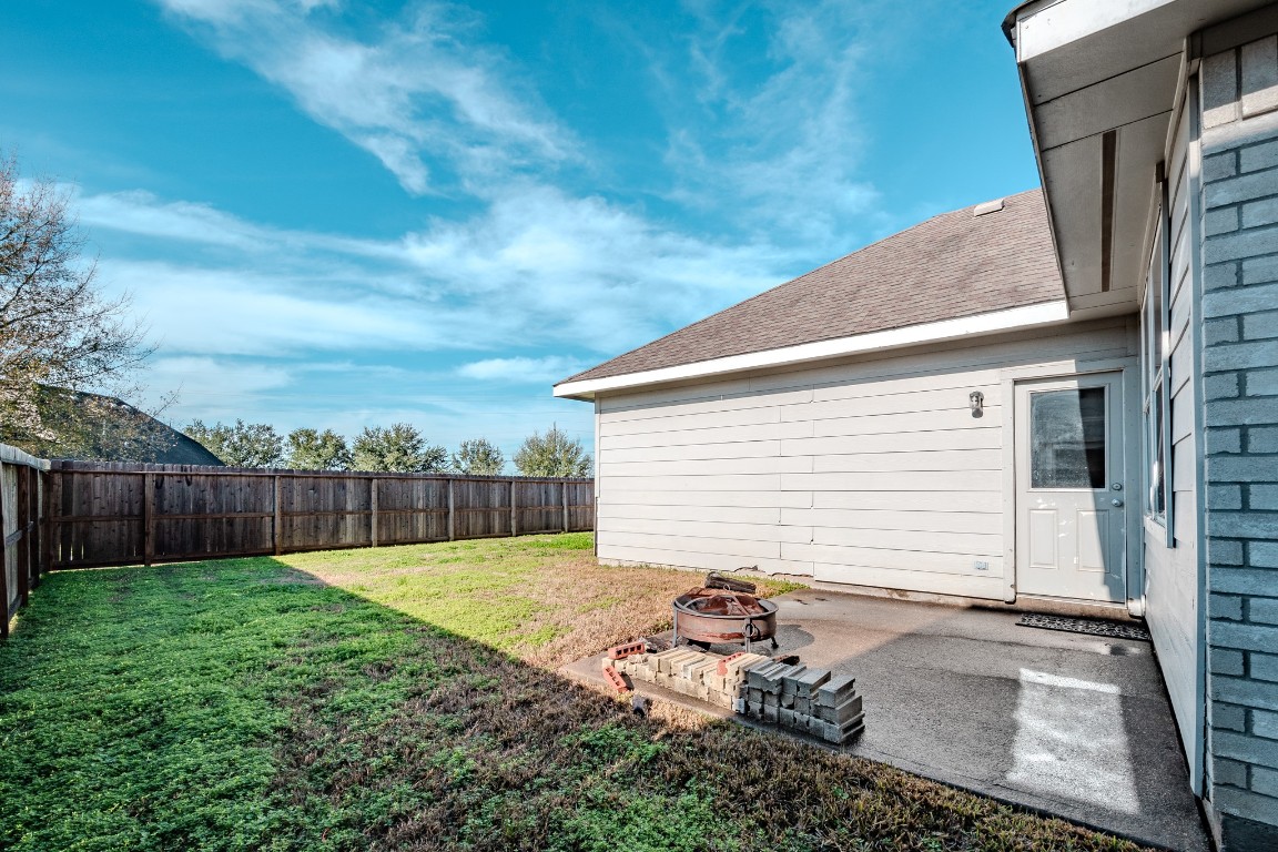 8515 Holly Spring Lane Baytown, TX 77523 - Photo 26 of 28 Patio area into large fenced back yard.