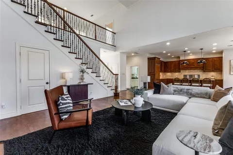 a living room with furniture kitchen view and a table