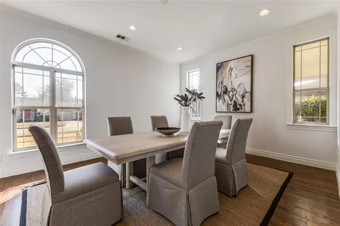 a view of a dining room with furniture a couch and wooden floor