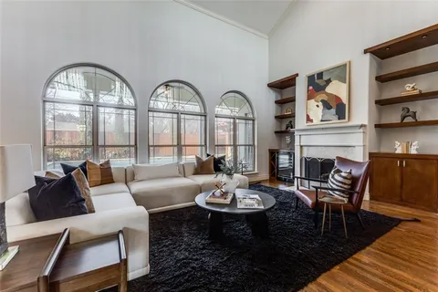 a living room with fireplace furniture and a wooden floor
