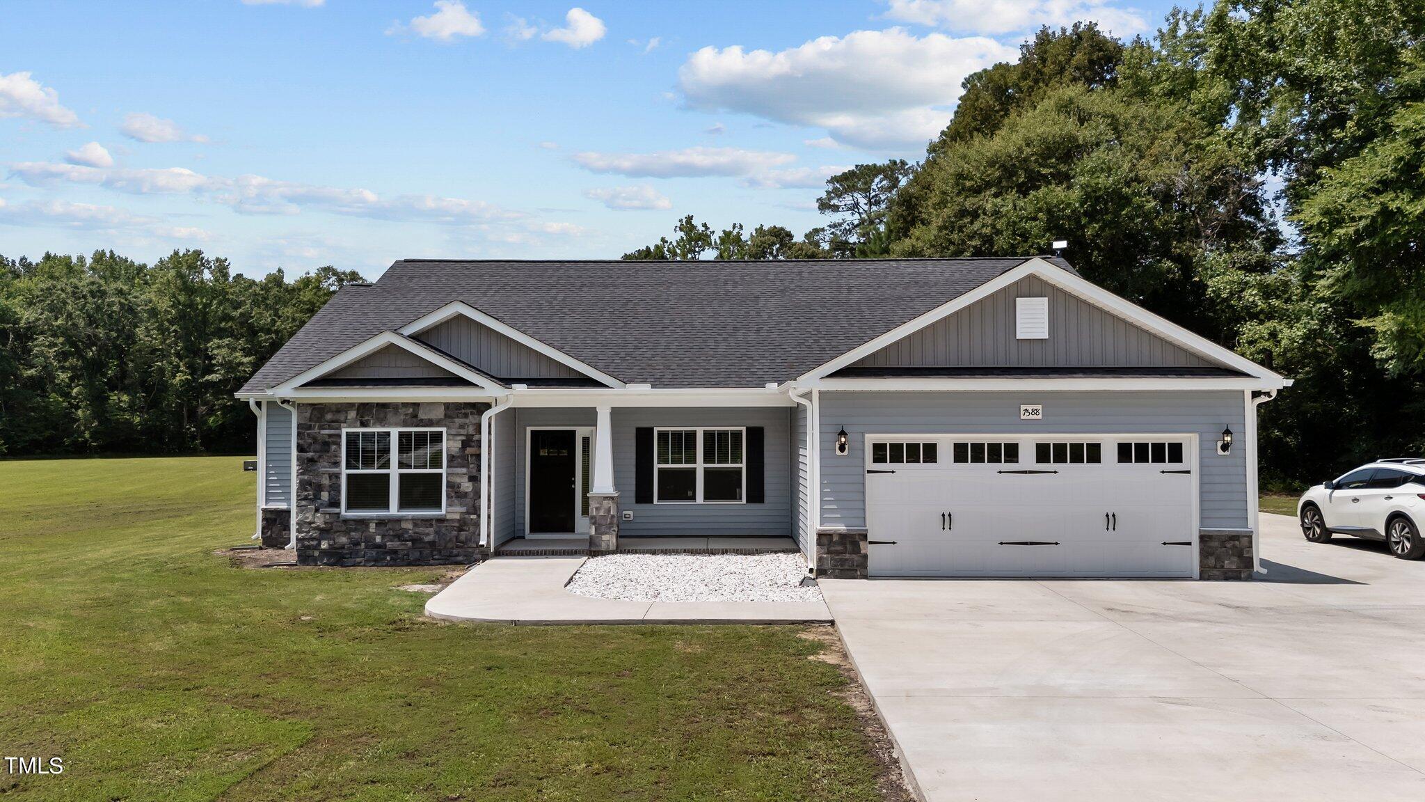 7588 Sadie Road Kenly, NC 27542 - Photo 15 of 58 a front view of a house with a yard