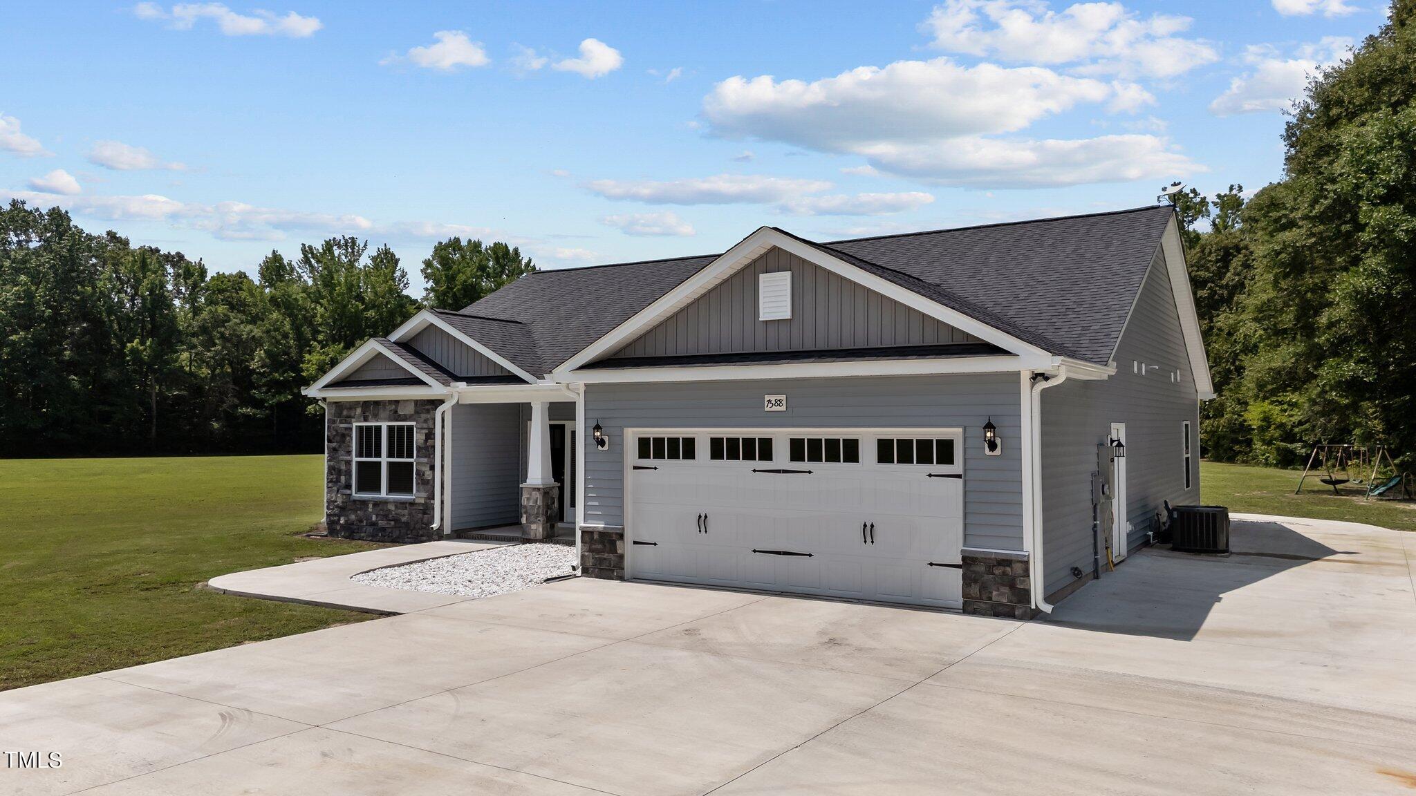 7588 Sadie Road Kenly, NC 27542 - Photo 16 of 58 a front view of a house with a yard