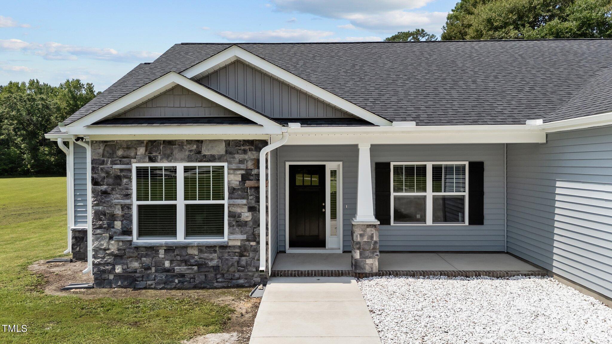 7588 Sadie Road Kenly, NC 27542 - Photo 17 of 58 a front view of a house with a garden