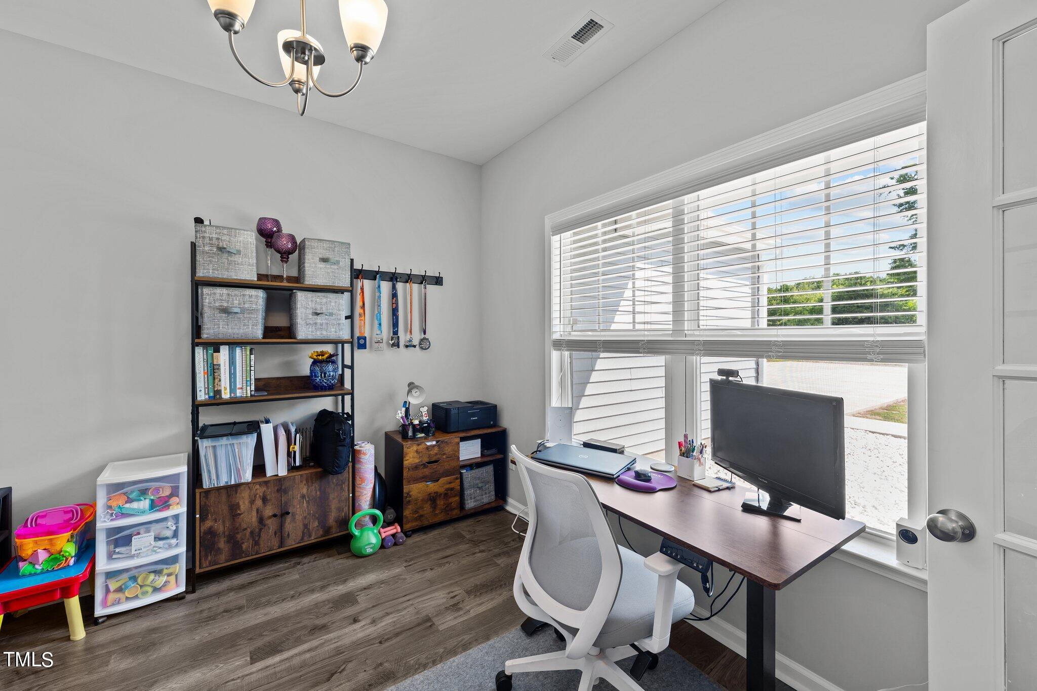 7588 Sadie Road Kenly, NC 27542 - Photo 20 of 58 a workspace with furniture hardwood and a window