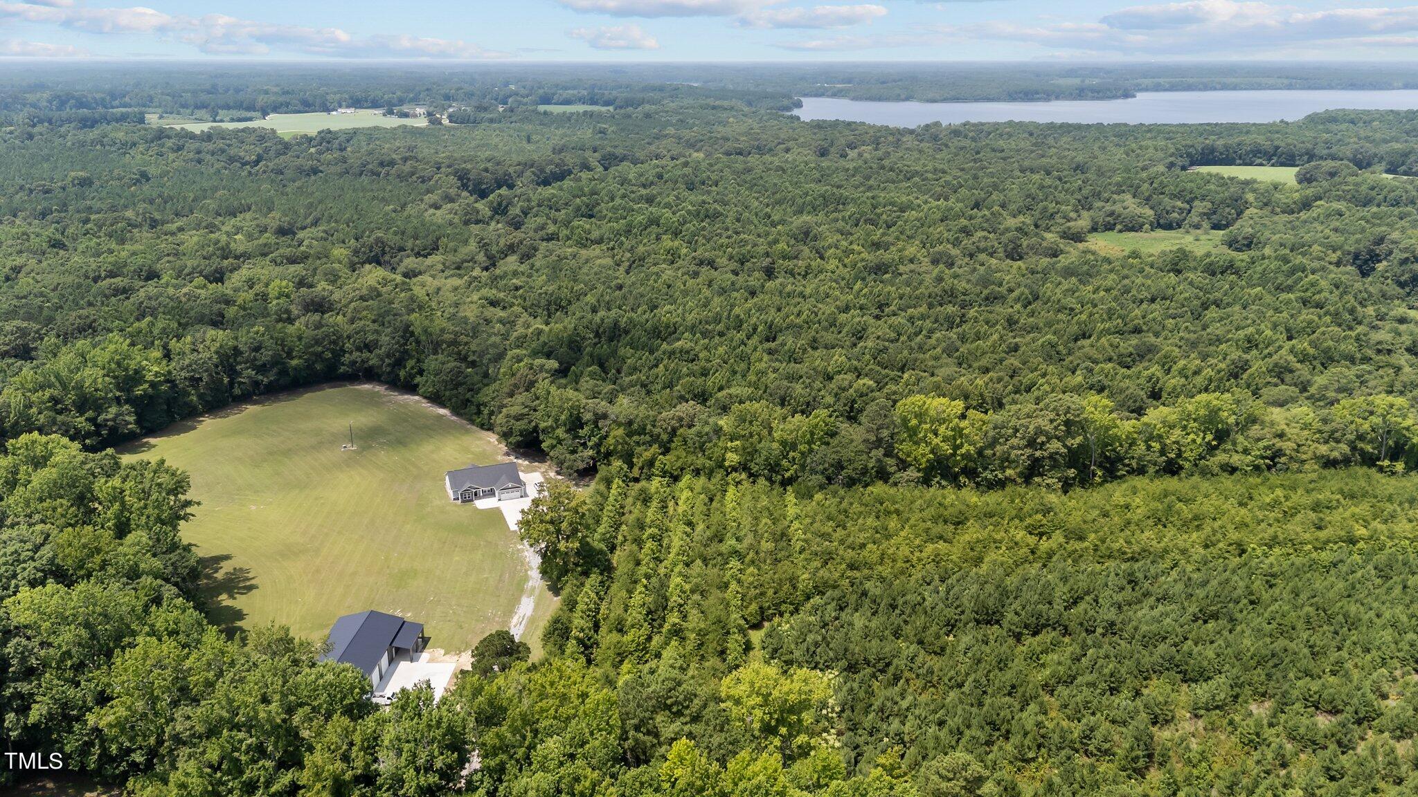7588 Sadie Road Kenly, NC 27542 - Photo 2 of 58 an aerial view of a residential houses with outdoor space and trees all around