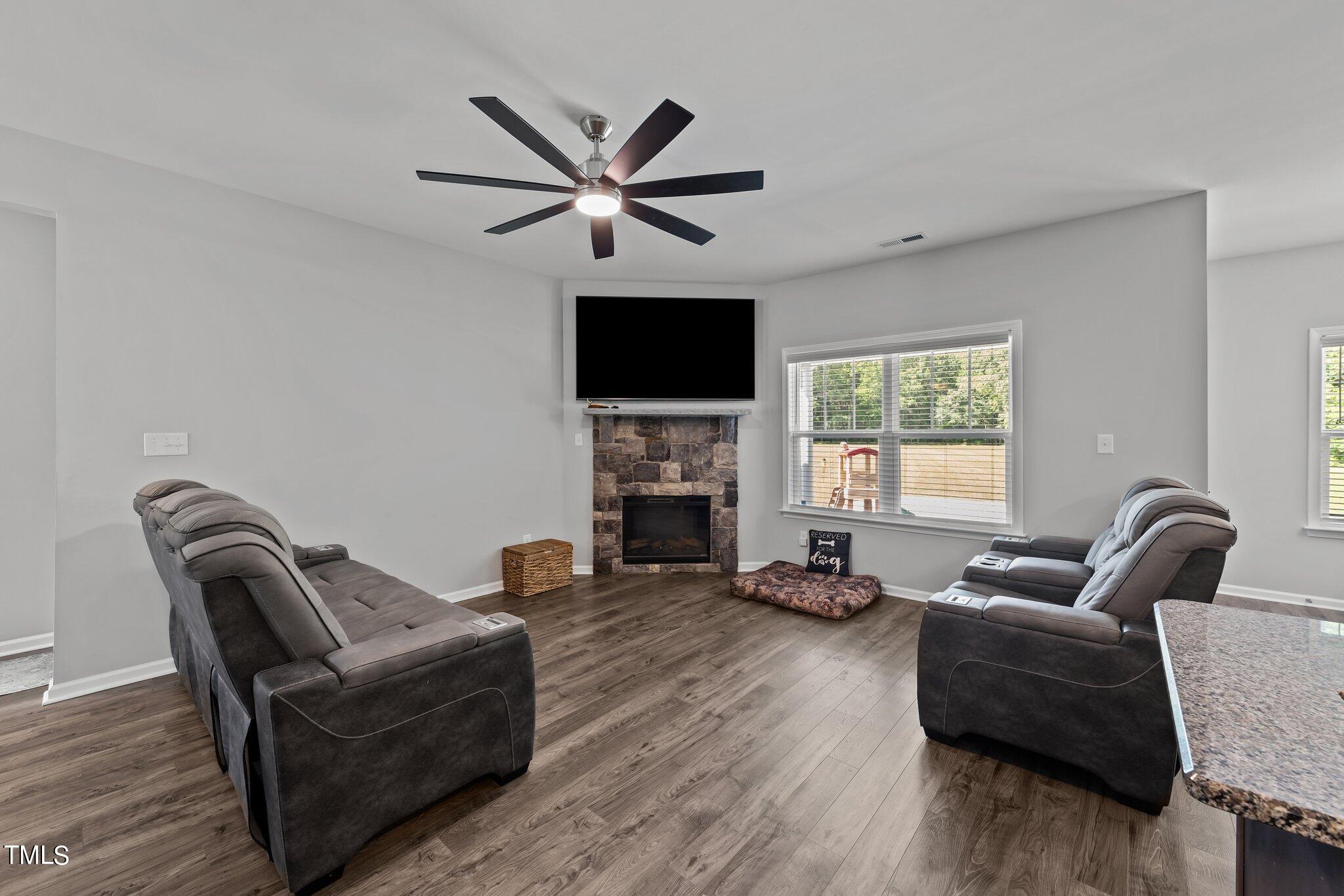 7588 Sadie Road Kenly, NC 27542 - Photo 22 of 58 a living room with furniture a fireplace and a flat screen tv
